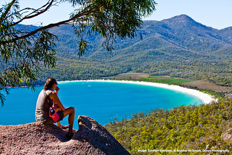 Woman looking out to Wineglass Bay, Freycinet National Park, Tasmania