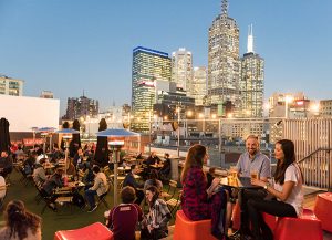 People enjoying a rooftop bar in Melbourne, Australia