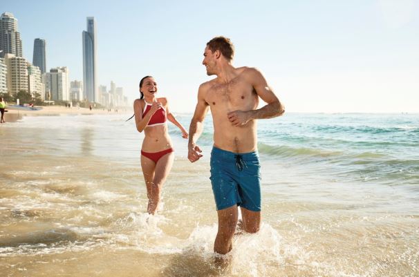 Couple on the beach in Surfers Paradise credit Tourism Queensland
