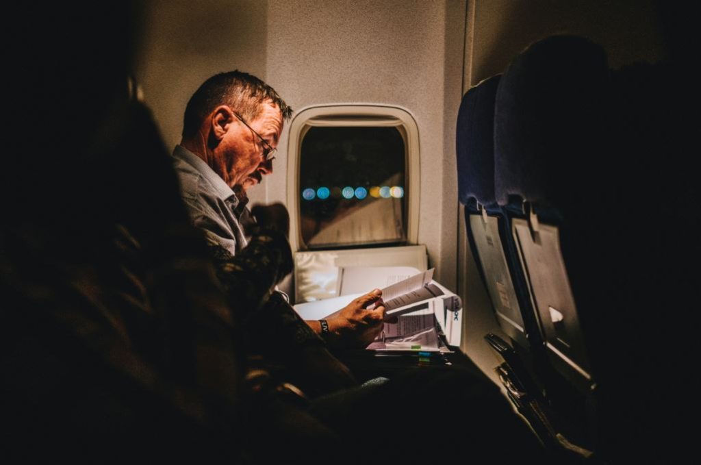 Man reading on plane 