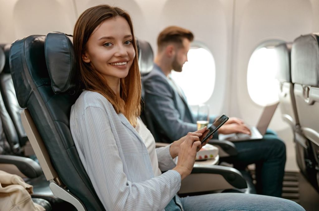 Woman sitting in an airplane ready for a flight to Australia